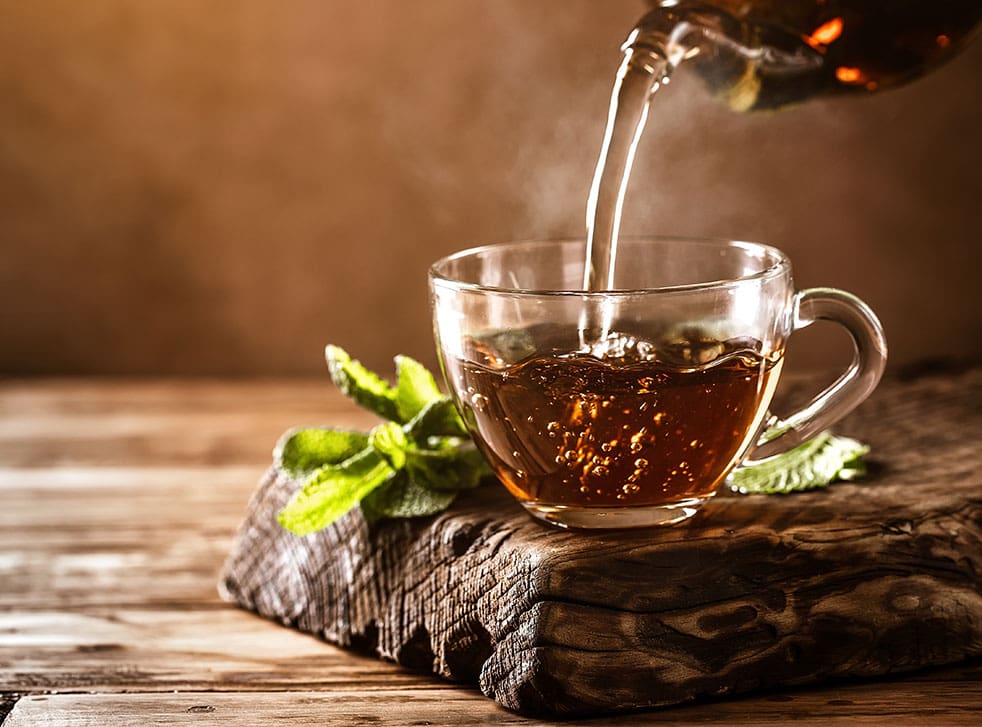 Cup of hot tea with fresh mint leaves
